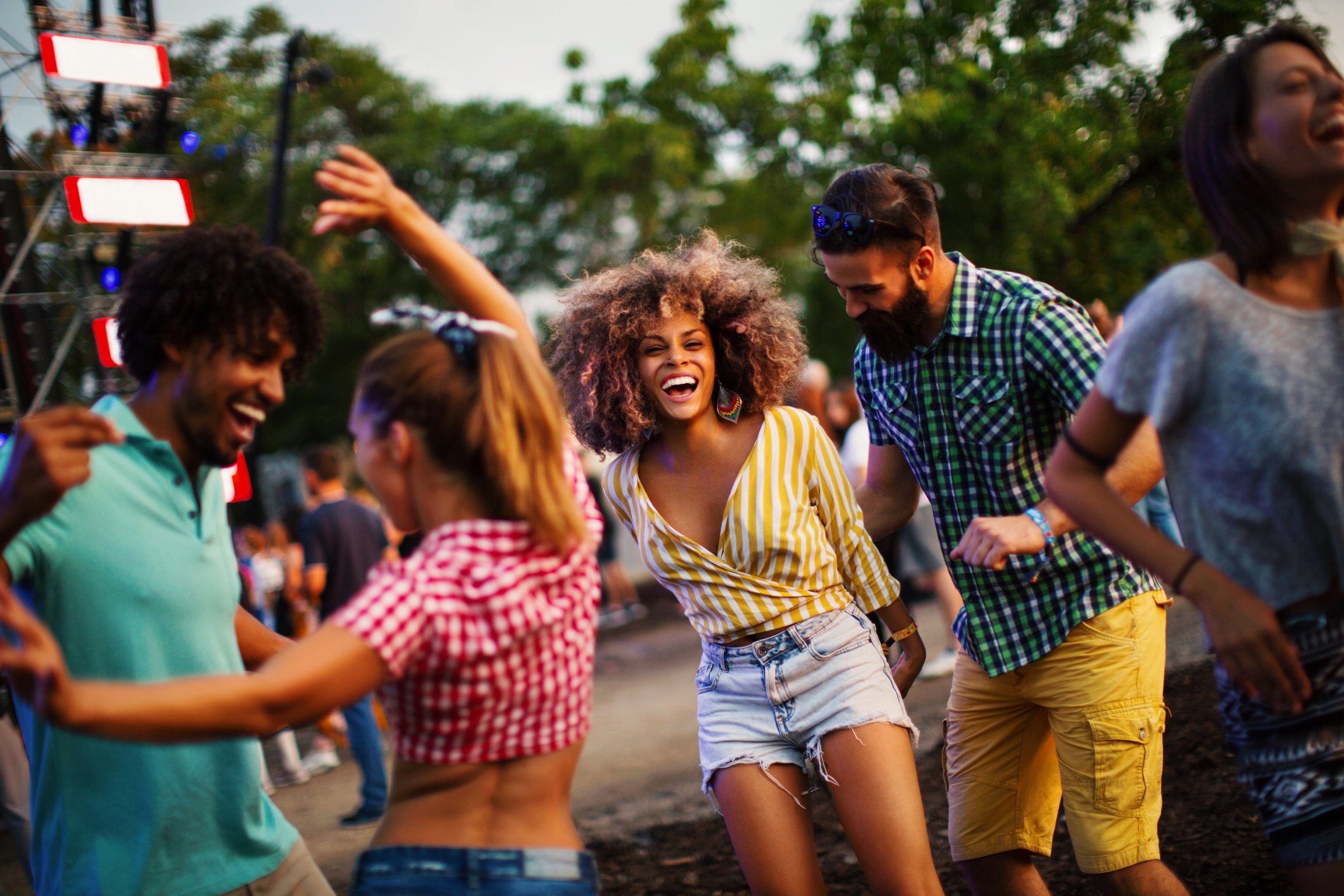 Friends dancing at music festival.